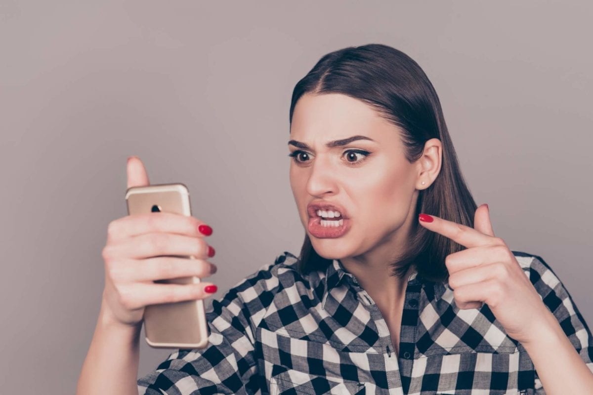 Elk River, MN woman angrily yelling and pointing at her phone