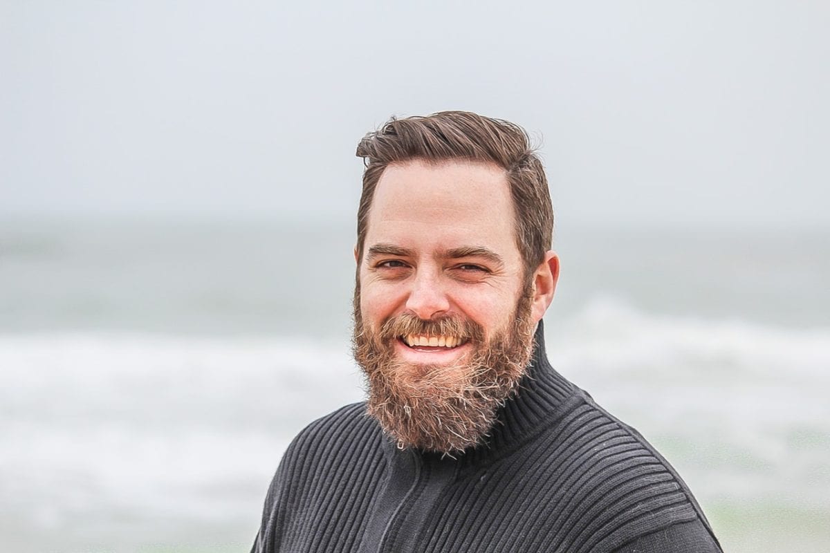Bearded Minnetonka Man in Midlife Transformation on a Beach